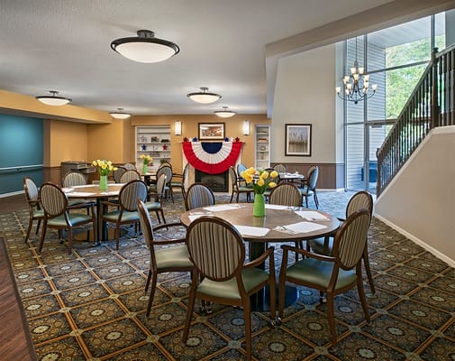 Bright dining room with tables and flowers