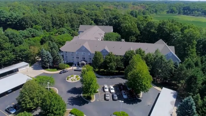 Aerial view of Baldwin House Senior Living facility surrounded by greenery