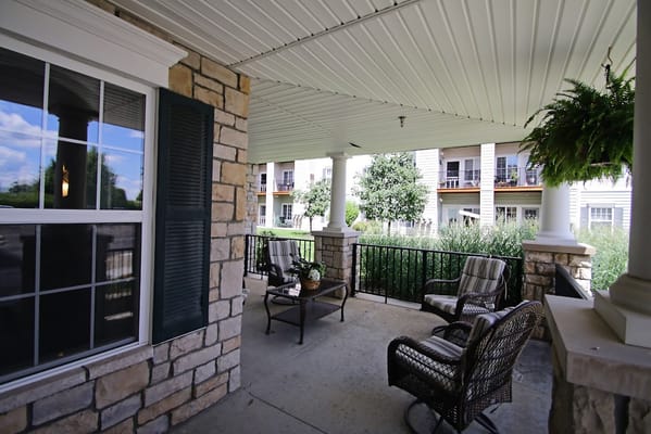 Covered outdoor seating area with views of greenery