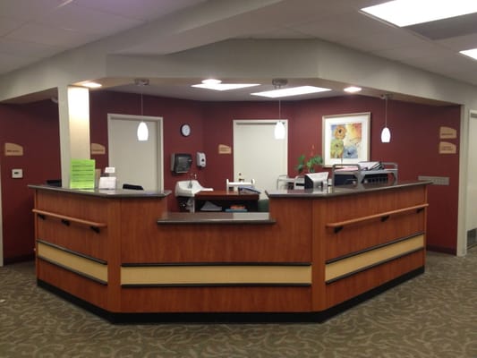 Reception area with wooden desk and office supplies