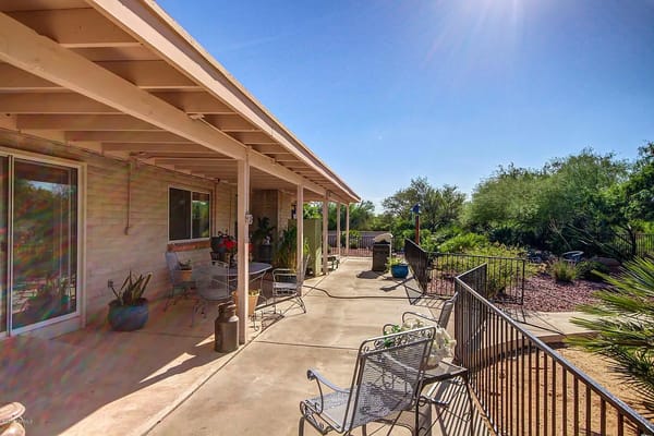 Outdoor patio area with seating and greenery