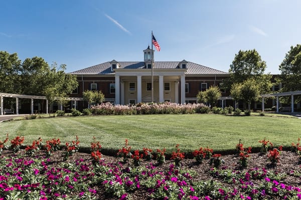 Exterior view of a senior living facility with landscaped gardens