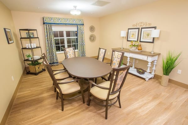 Bright common area with a dining set and decor