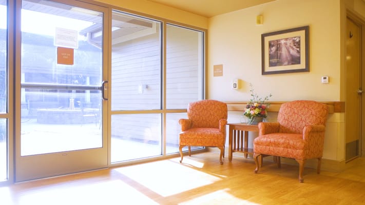 Bright common area with seating and floral decor
