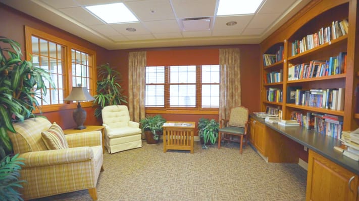 Cozy common area with seating and bookshelves