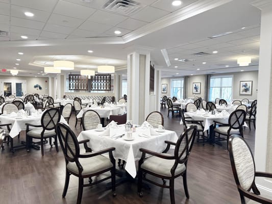 Dining room with neatly set tables and chairs