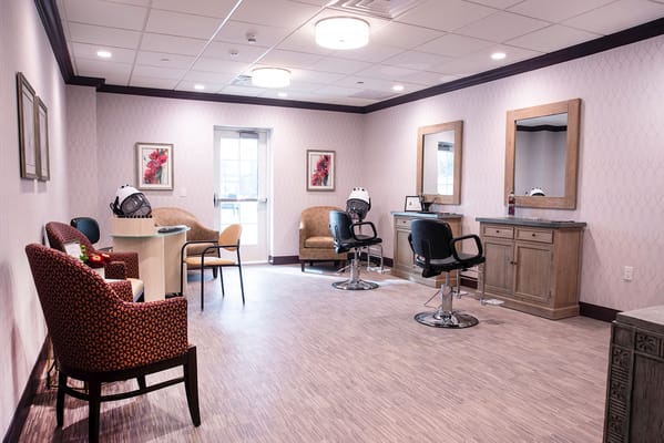 Hair salon area with styling stations and seating