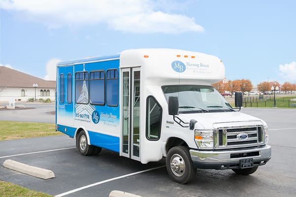 Blue bus of Morning Breeze Retirement Community parked in the facility lot