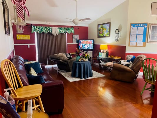 A cozy living room with comfortable seating and festive decorations.