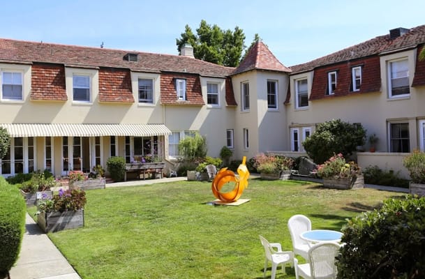 Outdoor garden area with seating and a sculpture