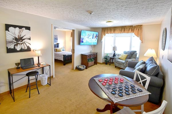Comfortable living area featuring a sofa, TV, and games table.