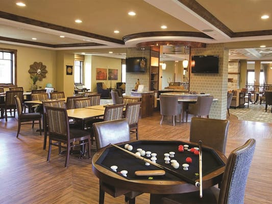 Comfortable common area featuring dining tables and a billiard table.