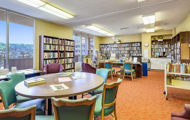 Interior view of a library with bookshelves and tables
