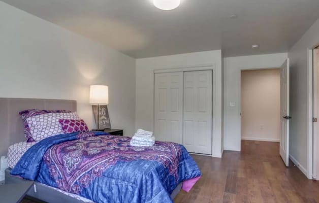 Private room with a bed and closet