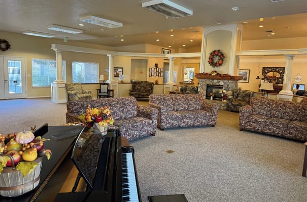 Common area with seating and fireplace, decorated for the season