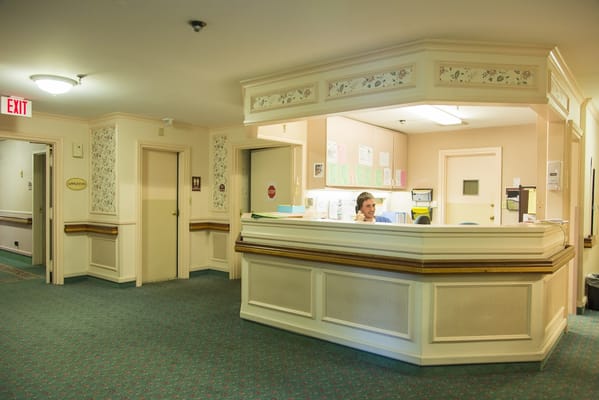 Reception area with staff at the front desk