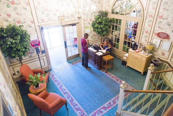 Staff member assisting a visitor in the lobby