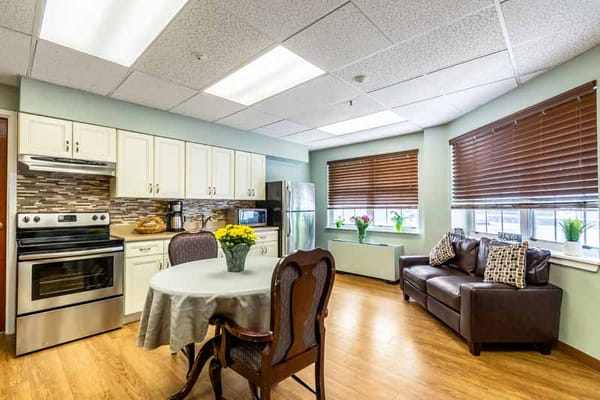 Bright and modern kitchen with dining area in a senior living facility