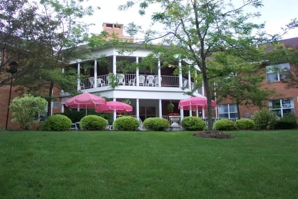 Outdoor patio with pink umbrellas at Royalton Woods