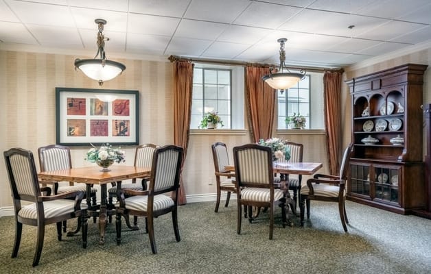 Bright and inviting common area with dining tables
