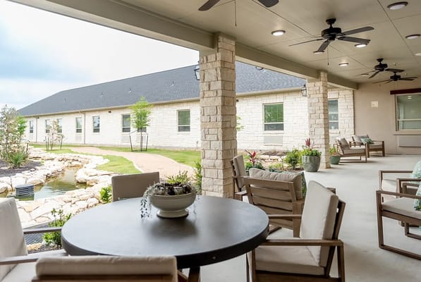 Outdoor patio area with seating and landscaping