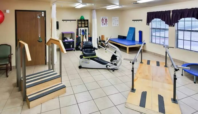 Therapy room featuring exercise equipment and steps for rehabilitation