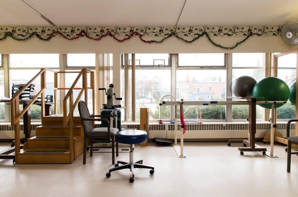 Interior of the therapy room with equipment and stairs.