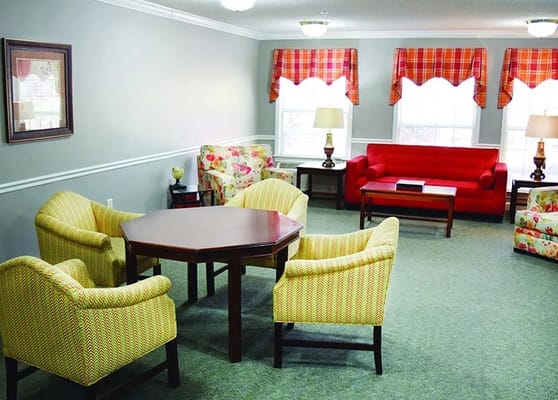Bright common area with floral furniture and natural light