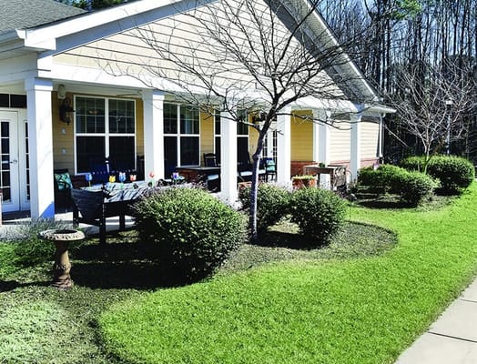 Exterior view of assisted living facility with landscaped garden