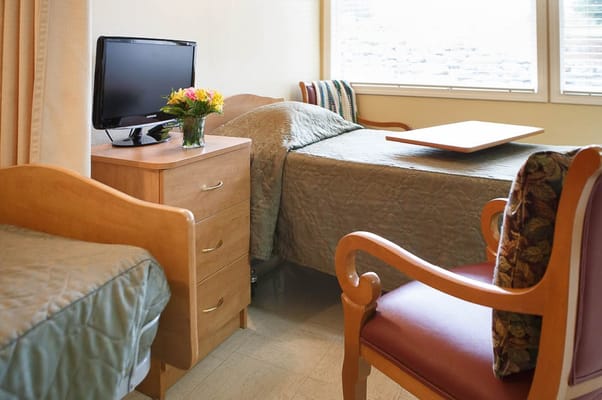 Cozy resident room with bed and television