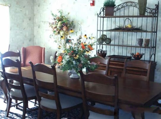 Bright dining room with wooden furniture and floral decor