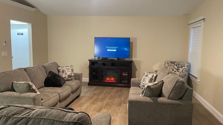 Comfortable living room with sofas and a TV