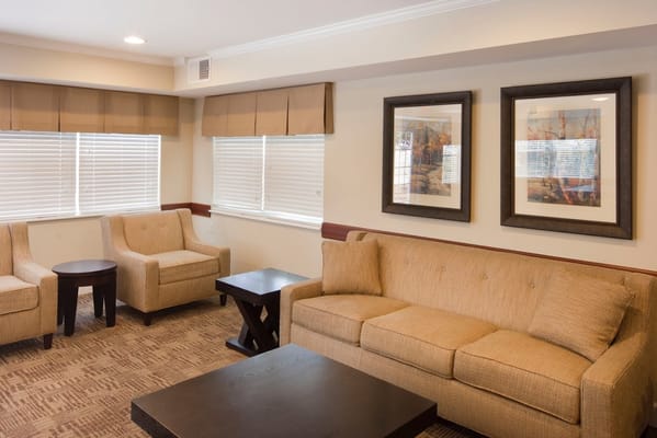 Lounge area with beige sofas and wooden tables