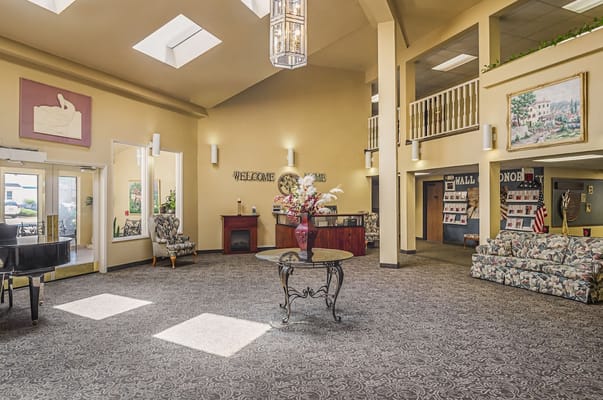 Bright and inviting lobby with a piano and floral arrangement