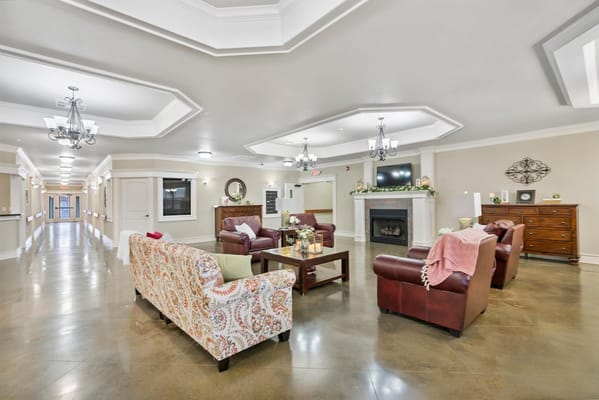 Cozy living room with seating and fireplace in StoneBridge Senior Living facility