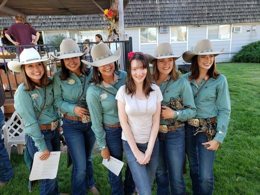 Group of residents with cowboy performers outdoors