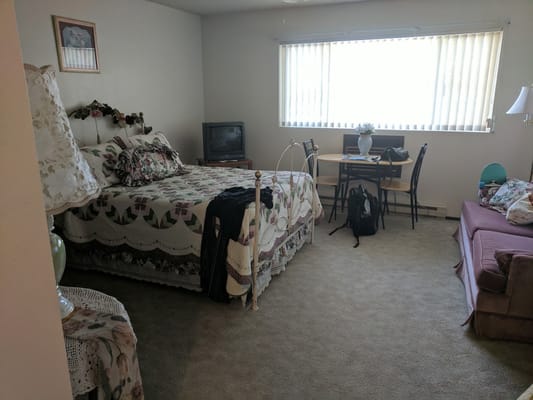 Cozy resident room with a bed and a table