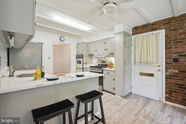 Modern kitchen with white cabinets and seating area