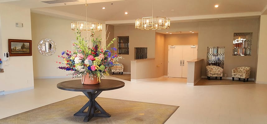 Bright and inviting lobby featuring a floral arrangement on a table.