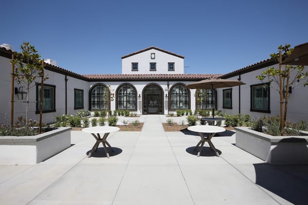 Bright courtyard with two tables and trees at Temecula Healthcare Center