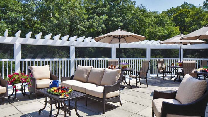 Patio with seating and umbrellas at The Cottage at Litchfield Hills