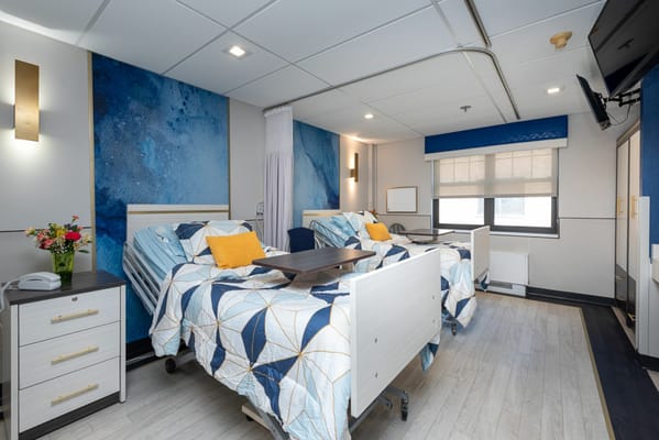 Modern private resident room with two beds and decor