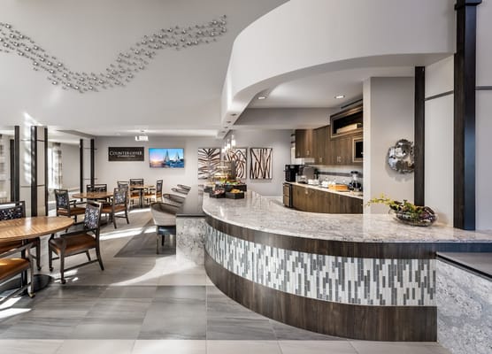 Modern dining area with tables and a curved counter