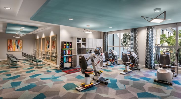 Modern fitness area with exercise equipment and mirrors