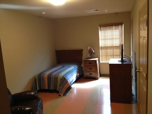 A private resident room with a bed and furniture