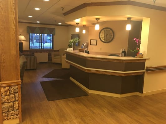 Welcoming reception area with wood accents and comfortable seating.