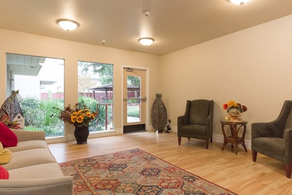 A welcoming lobby with seating and a view of the garden outside.