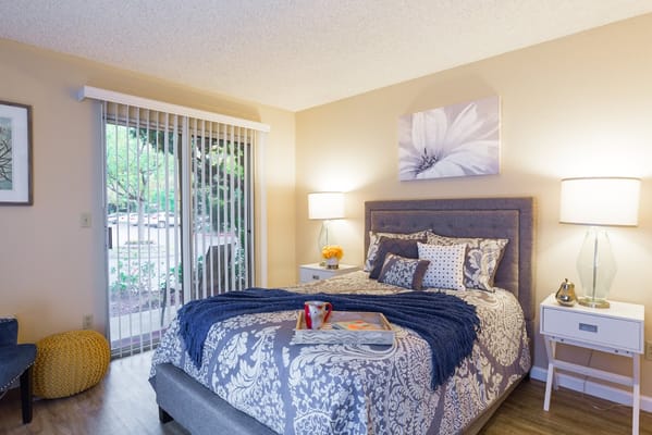 A comfortable bedroom with a neatly made bed and natural light