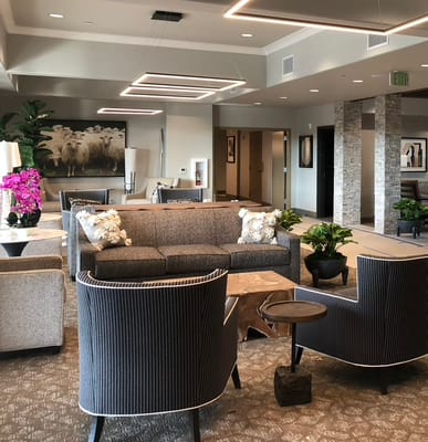 Modern lobby with seating, plants, and artwork