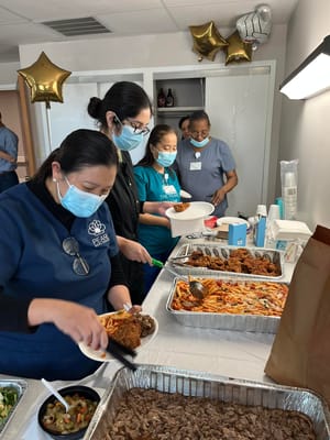 Staff serving food during a community meal event